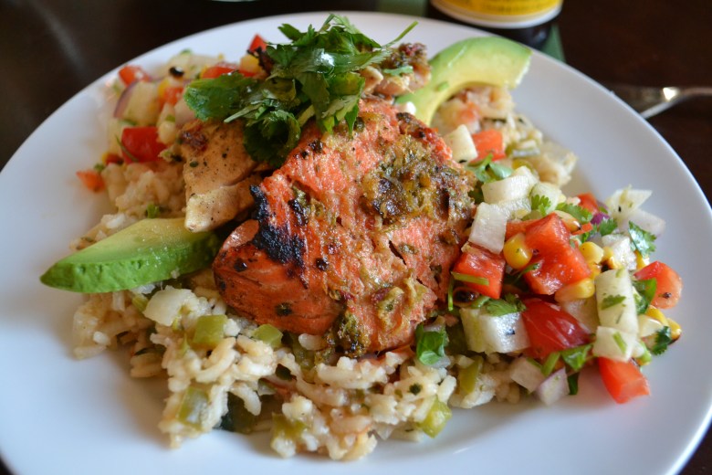 Drunken salmon and rockfish with jicama and grilled corn salsa over a bed of Mexican veggie rice
