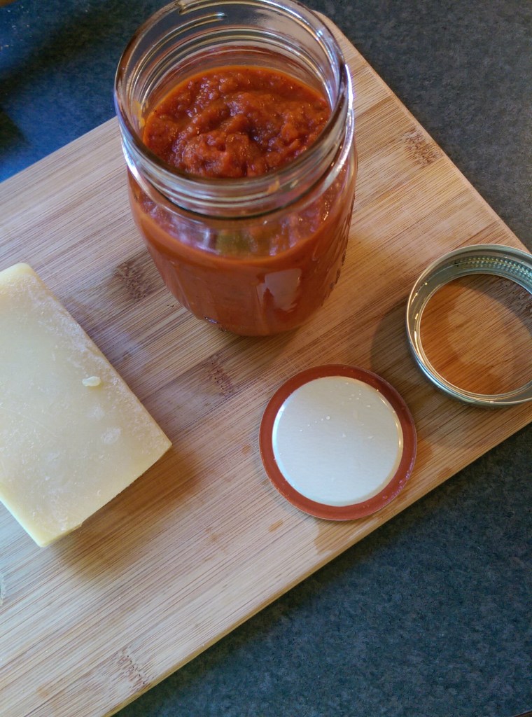 The finished product, in a jar, next to a wedge of parmesean - because it looks fancy